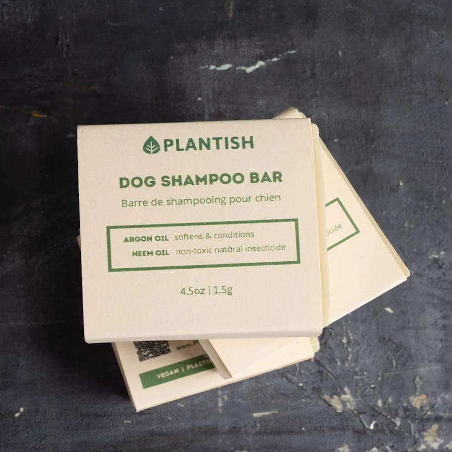 Plantish dog shampoo bar packaging on a dark surface