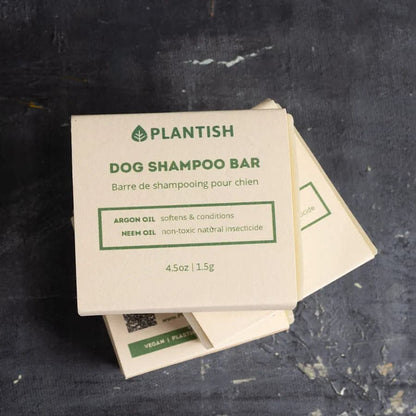 Plantish dog shampoo bar packaging on a dark surface