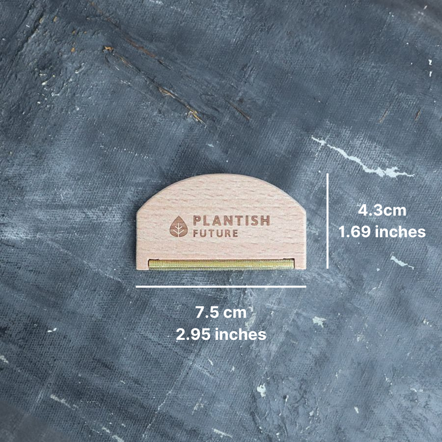 Small wooden tool with 'Plantish Future' branding on a textured gray background