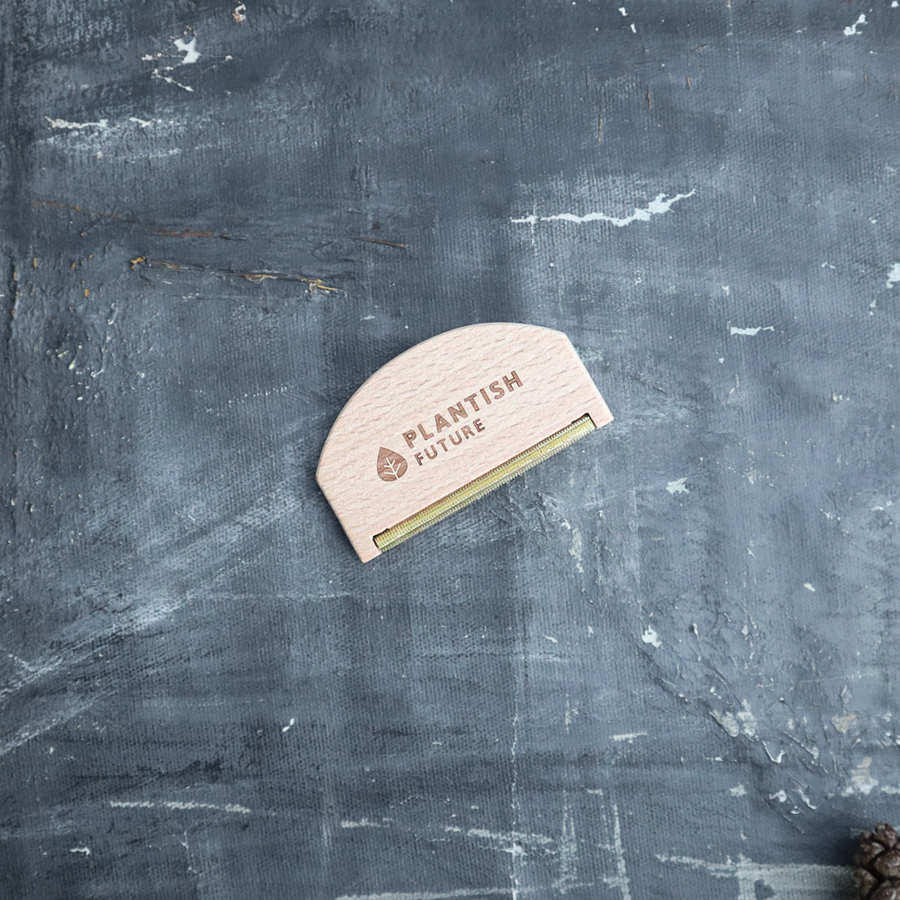 Small wooden tool with 'Plantish Future' branding on a textured gray background