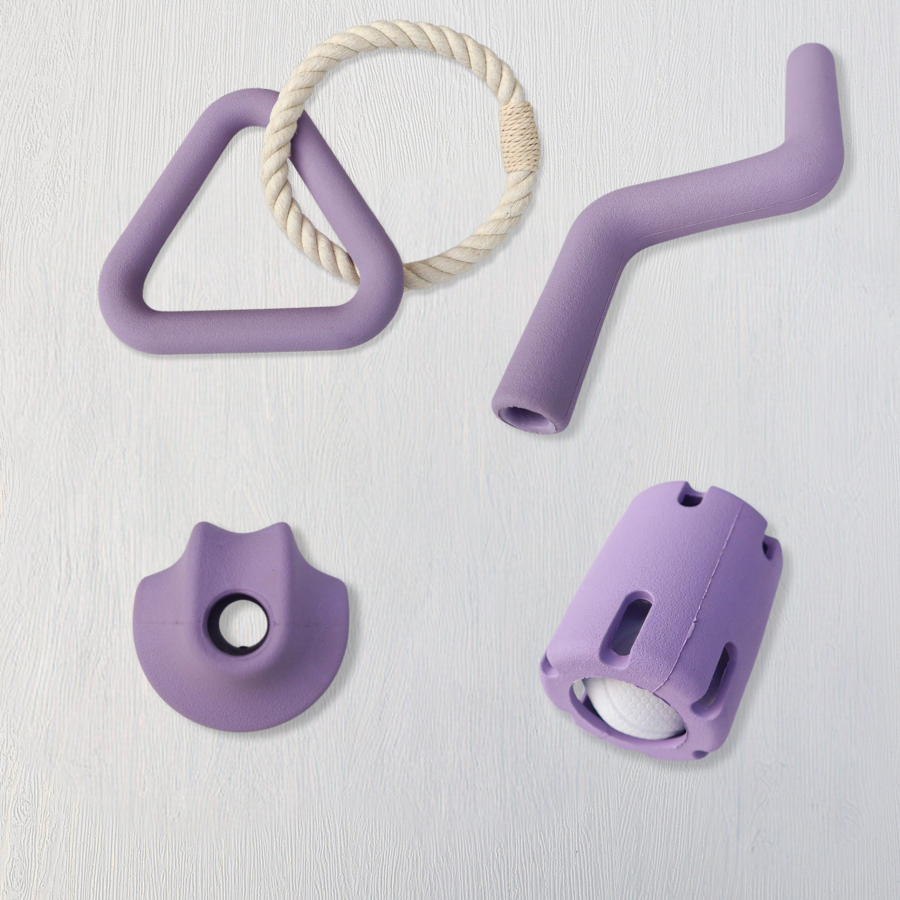 Set of purple pet toys including a triangle, tube, and circular shapes on a light gray background